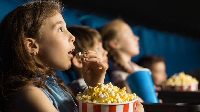Watching Top 34 Must-Watch Movies with popcorn