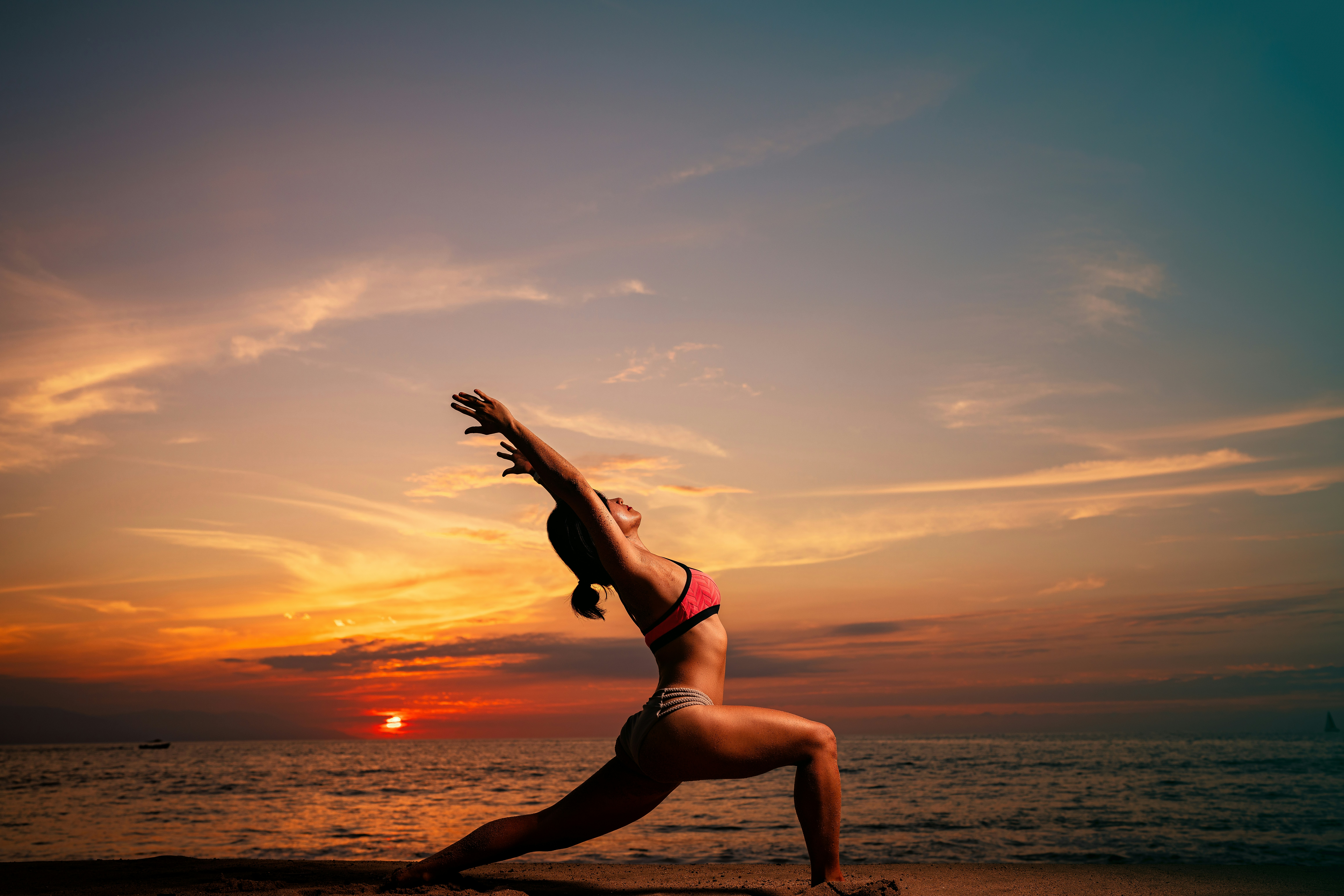 Woman doing yoga by the sea