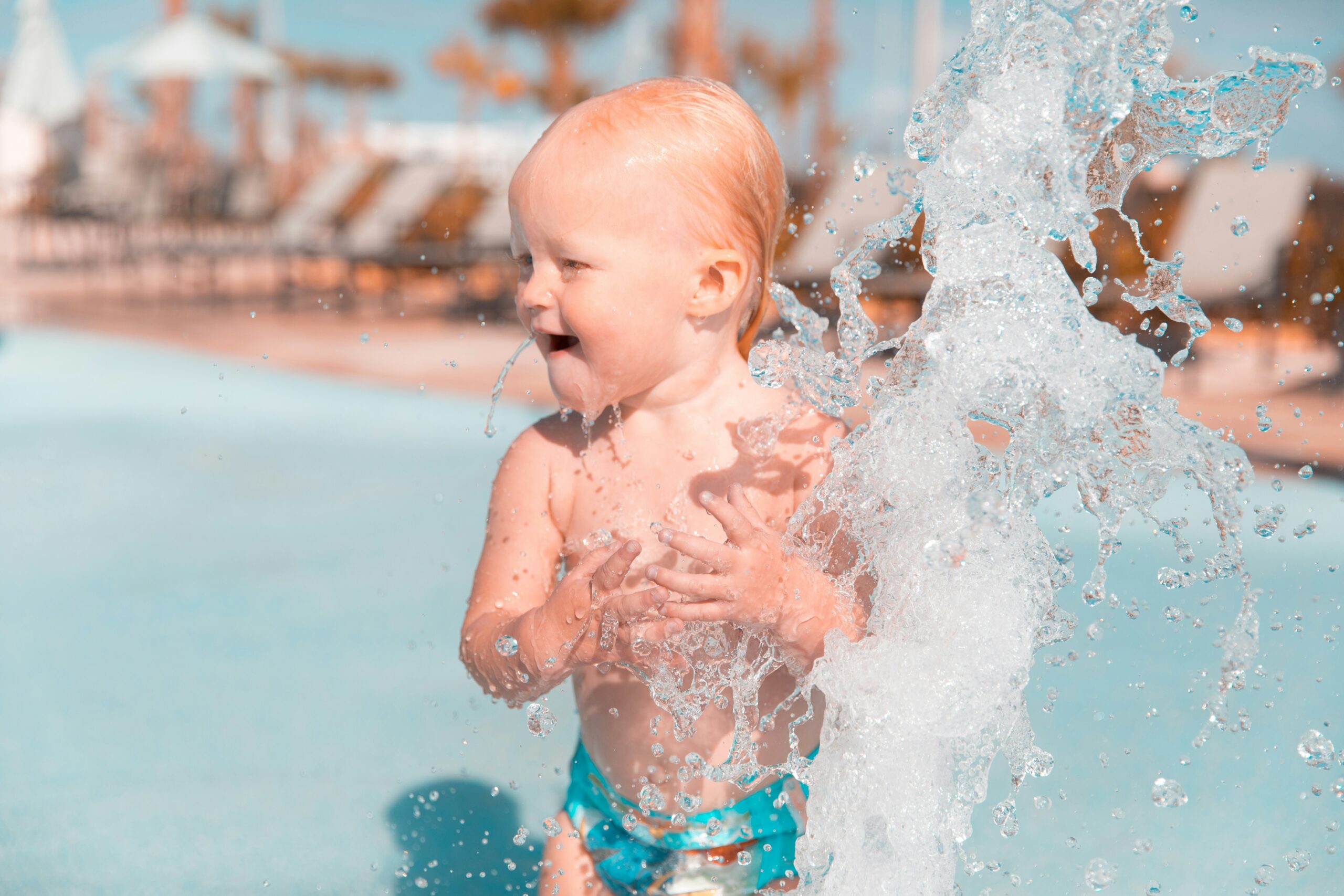 Child playing in water at a water park.